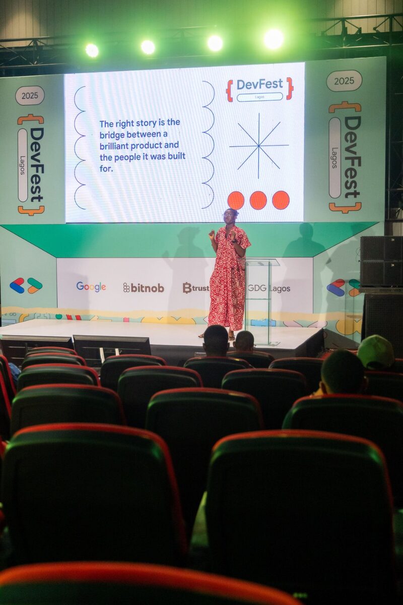 Praise James speaking on stage at DevFest Lagos 2025